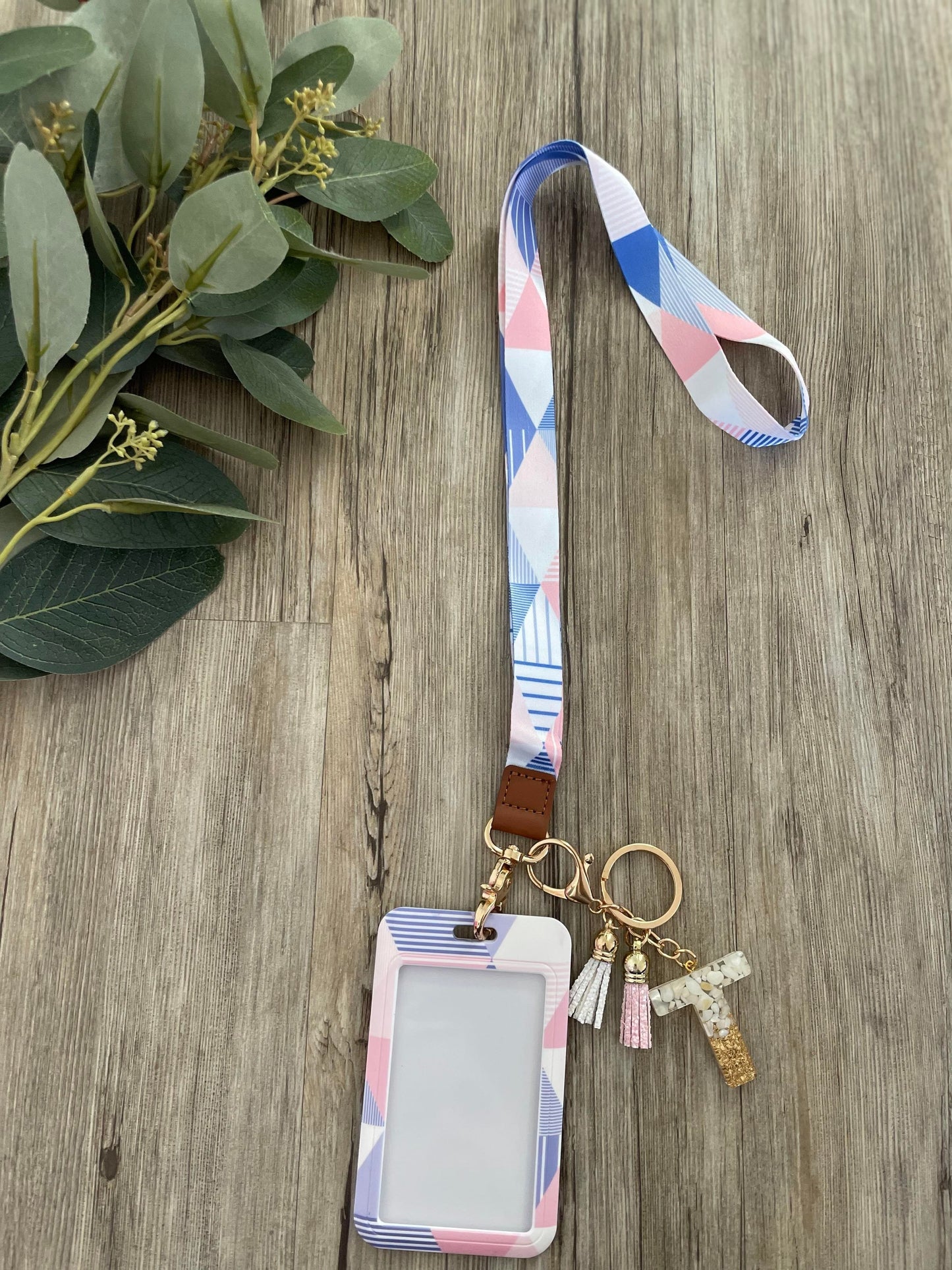 Lanyard with blue geometric tones and ID card holder. 